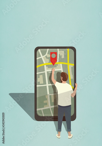 Man reaching for map pin icon on large smart phone photo