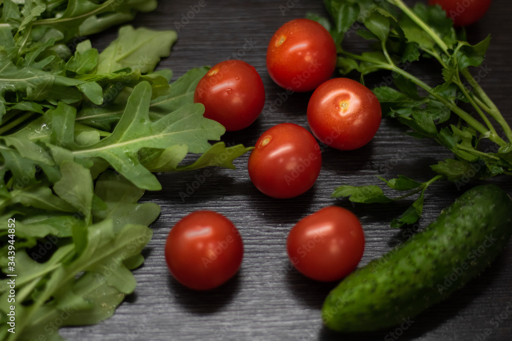 fresh tomatoes, cucumbers and greens for a salad fresh tomatoes, cucumbers and greens for a salad