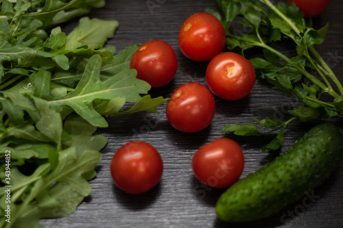 fresh tomatoes, cucumbers and greens for a salad
