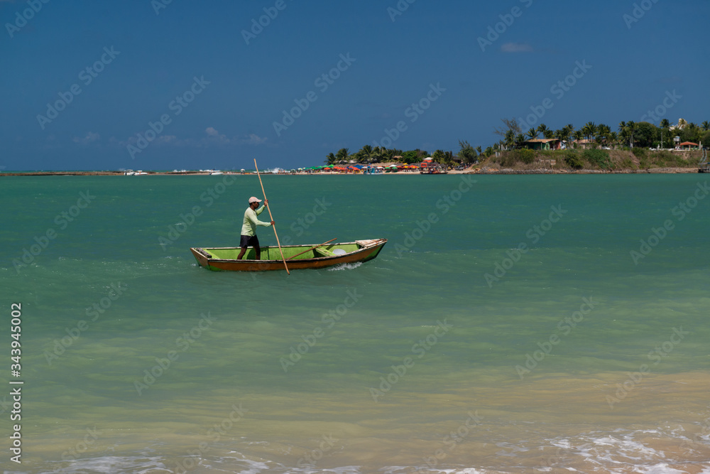 Small boat with fisherman in Pipa beach, Tibau do sul, near Natal, Rio Grande do Norte, Brazil on September 25, 2016 Small boat with fisherman in Pipa beach, Tibau do sul, near Natal, Rio Grande do Norte, Brazil on September 25, 2016