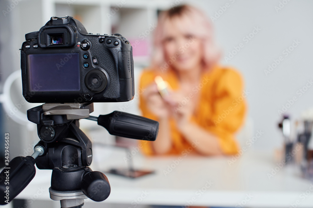 Pretty woman recording a video at home Pretty woman recording a video at home