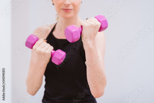 group of women practicing sport at the gym with dumbbells. Healthy lifestyle