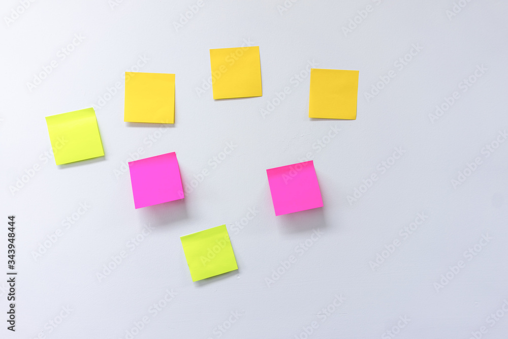 Photos of various colored notepad on a white board Photos of various colored notepad on a white board