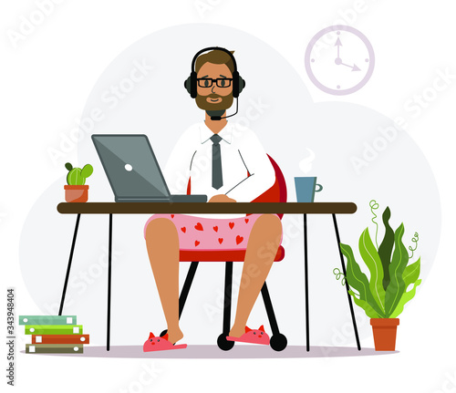 A man in underpants and slippers, a programmer works at home at a computer, a laptop. 