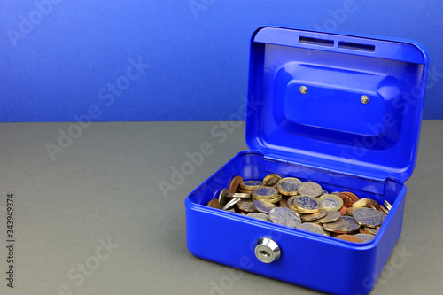 Coins in a security tin