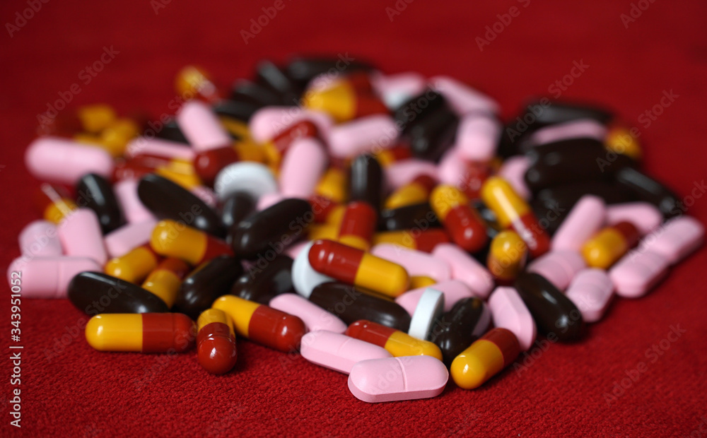 Closeup shot: colorful pills, vitamins, analgesics and antibiotics. Health support and treatment, medication, prescription drugs, vitamin tablets. Closeup shot: colorful pills, vitamins, analgesics and antibiotics. Health support and treatment, medication, prescription drugs, vitamin tablets.