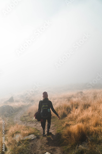 woman hiking in fog  © Mark