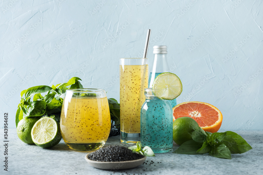 Basil seeds beverage with orange and tropical juice in glasses on light background. Close up. Healthy detox cocktail for lose weight. Basil seeds beverage with orange and tropical juice in glasses on light background. Close up. Healthy detox cocktail for lose weight.