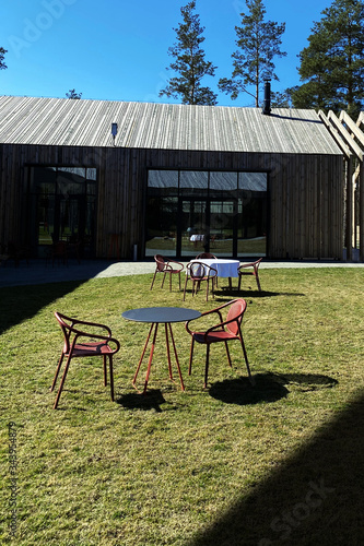 Beautiful view of tables and chairs on lawn at country complex