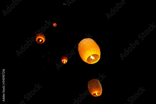 Colorful circle paper floating lanterns are flying to dark night skies in Probarona Purnima festival. photo