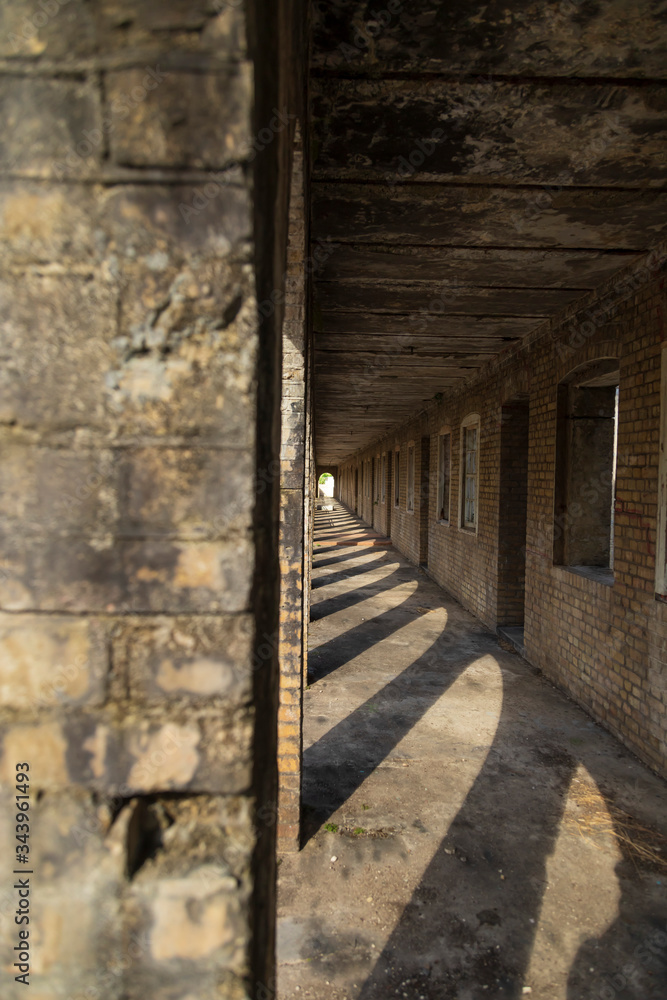 old abandoned brick building with arches and a long corridor with a vanishing point single point perspective