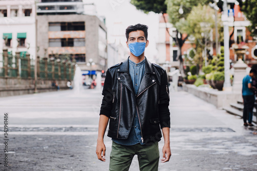 latin man wearing mask face to prevent infection or respiratory illness, Mexican man with Protection against contagious coronavirus in Mexico Latin America