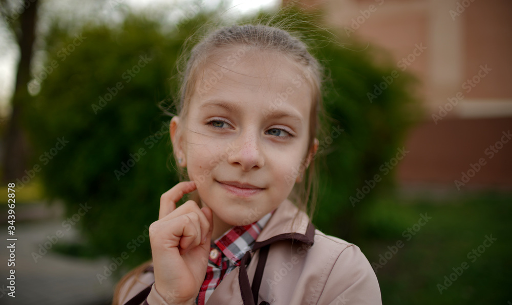 Portrait of pretty girl with long bundled hair in spring in park Portrait of pretty girl with long bundled hair in spring in park