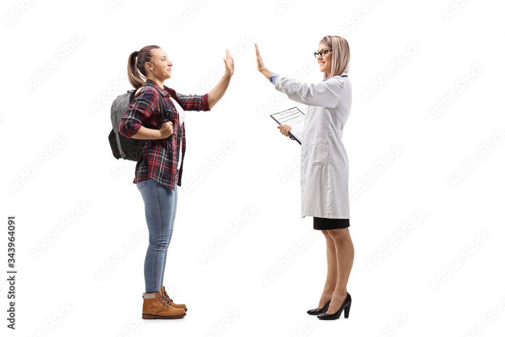 Fototapeta premium Female student gesturing high-five with a female doctor