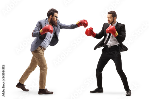 Two men in formal clothes fighting with boxing gloves