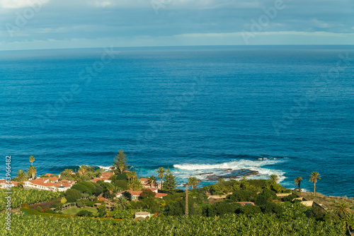 Farm village by the coast of Tenerife with blue sea water photo