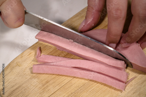 Knife sausage on a wooden stand on a table