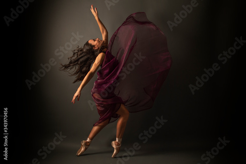 Graceful ballet dancer or classic ballerina dancing isolated