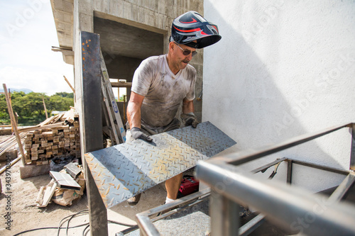 Man works on construction site, building staircase. photo