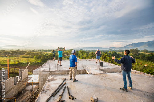 Group of men praising God from rooftop in the morning.