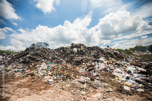 General view of rubbish piled on a landfill full of trash, burning. photo