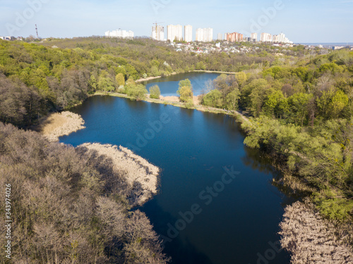 Forest lake on a spring day. Aerial drone view.