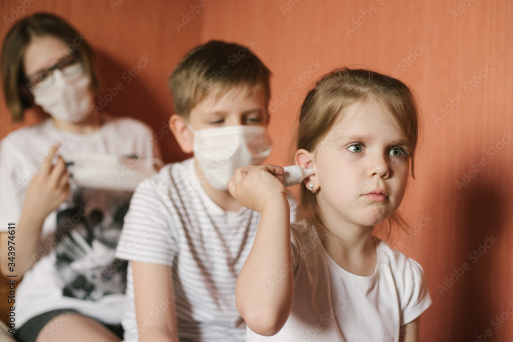 Children in masks measure the temperature.. Children are asked to leave at home, because the window is COVID. A fair-haired boy in blue gloves asks to stay at home. Children in masks measure the temperature.. Children are asked to leave at home, because the window is COVID. A fair-haired boy in blue gloves asks to stay at home.
