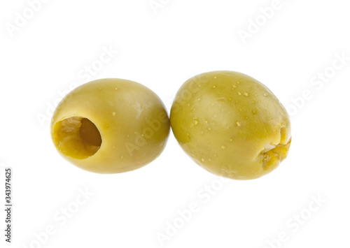 two green pitted olives on a white background isolated