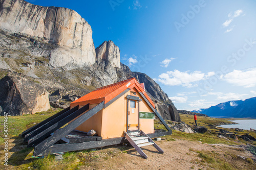 Backpacker stands outside of the North Pangnirtung Emergency shelter photo