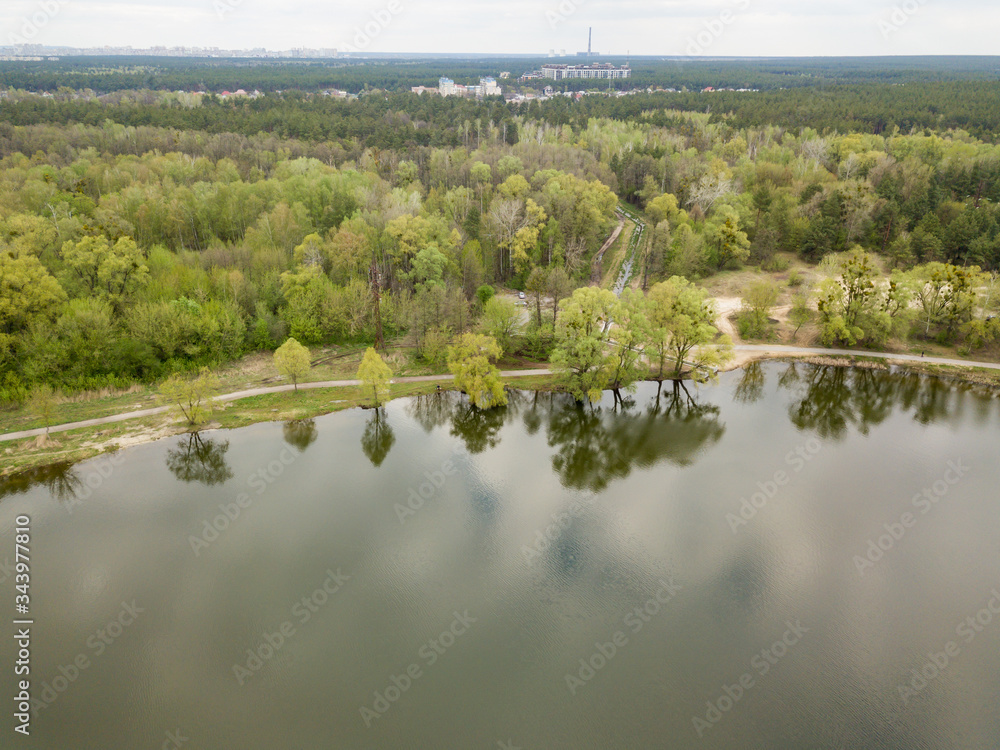Shore of a forest lake on a spring day. Aerial drone view. Shore of a forest lake on a spring day. Aerial drone view.