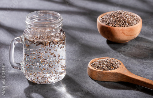 Organic chia seeds and glass of filtered water - Salvia hispánica photo