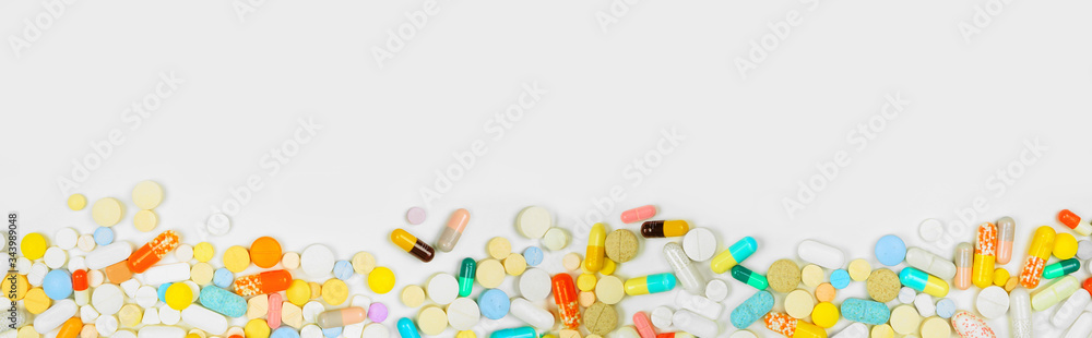 Border of assorted medicines on a white banner background with copy space Border of assorted medicines on a white banner background with copy space