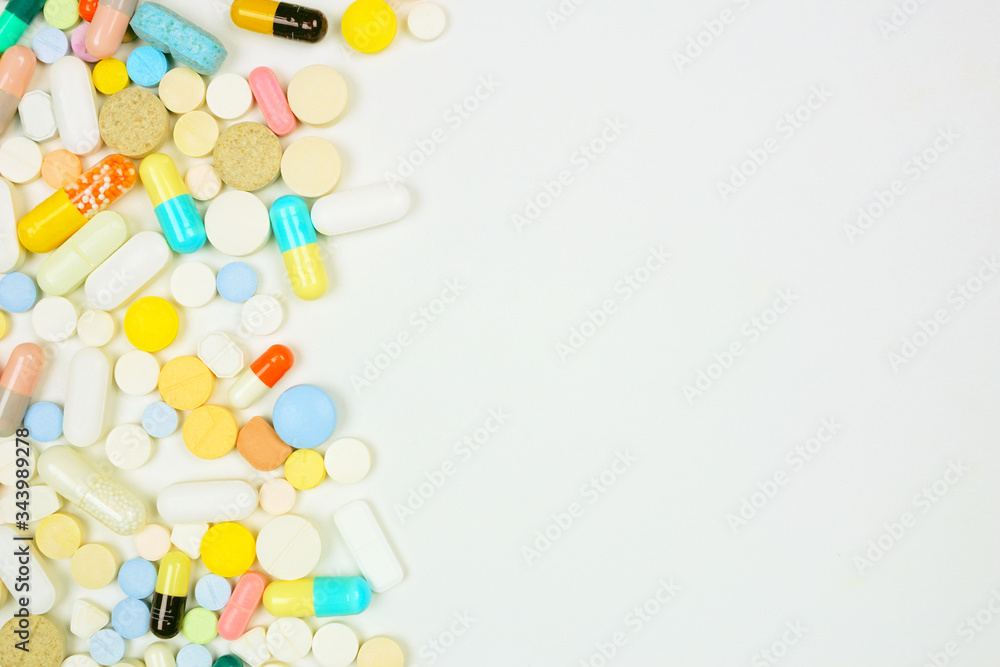 Side border of assorted medicines on a white background with copy space Side border of assorted medicines on a white background with copy space
