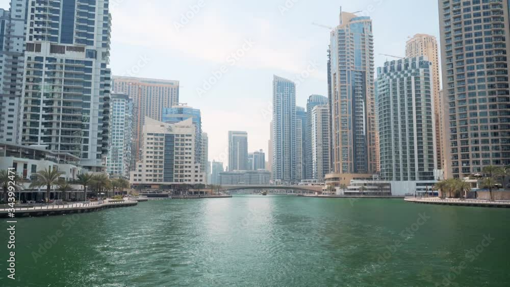 Dubai Marina canal with azure water and high rise buildings, United Arab Emirates Dubai Marina canal with azure water and high rise buildings, United Arab Emirates