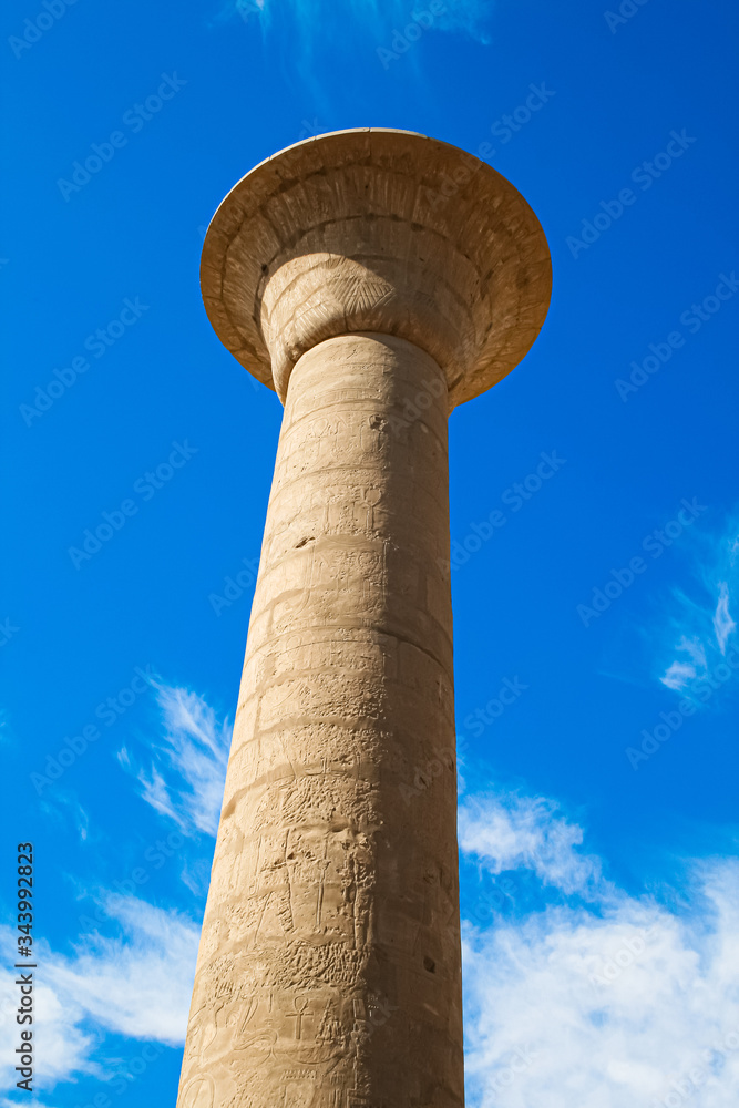 Ruins giants pillar in lotus style of ancient Egyptian still stand under blue sky at the ruined great ancient Egyptian temple of Amun at Karnak