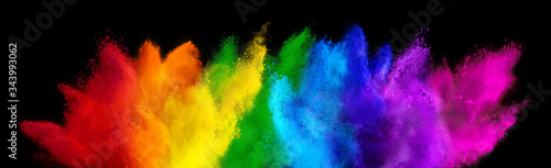 colorful rainbow holi paint color powder explosion isolated dark black wide panorama background. peace rgb beautiful party concept © stockphoto-graf