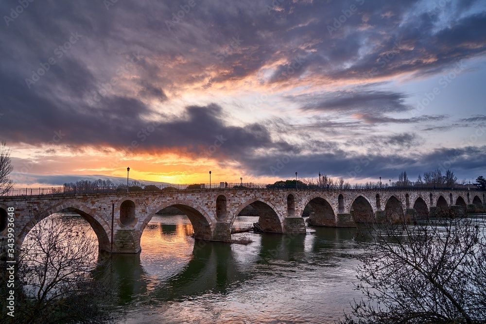 Sunrise over the romanesque bridge in Zamora city