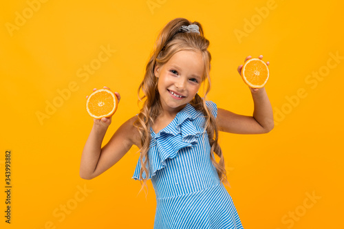 joyful blond attractive girl with oranges on a yellow background © Ivan Traimak