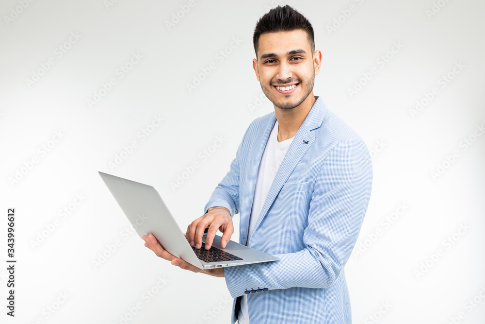 smiling office worker man with an open laptop in his hands on a white studio background smiling office worker man with an open laptop in his hands on a white studio background