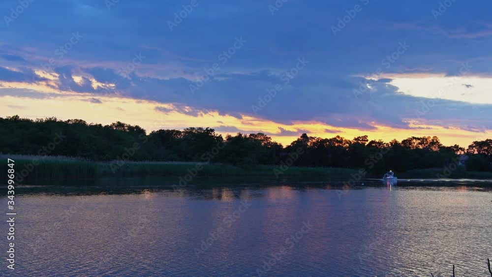 Motorboat floating racing through the river at sunset Motorboat floating racing through the river at sunset