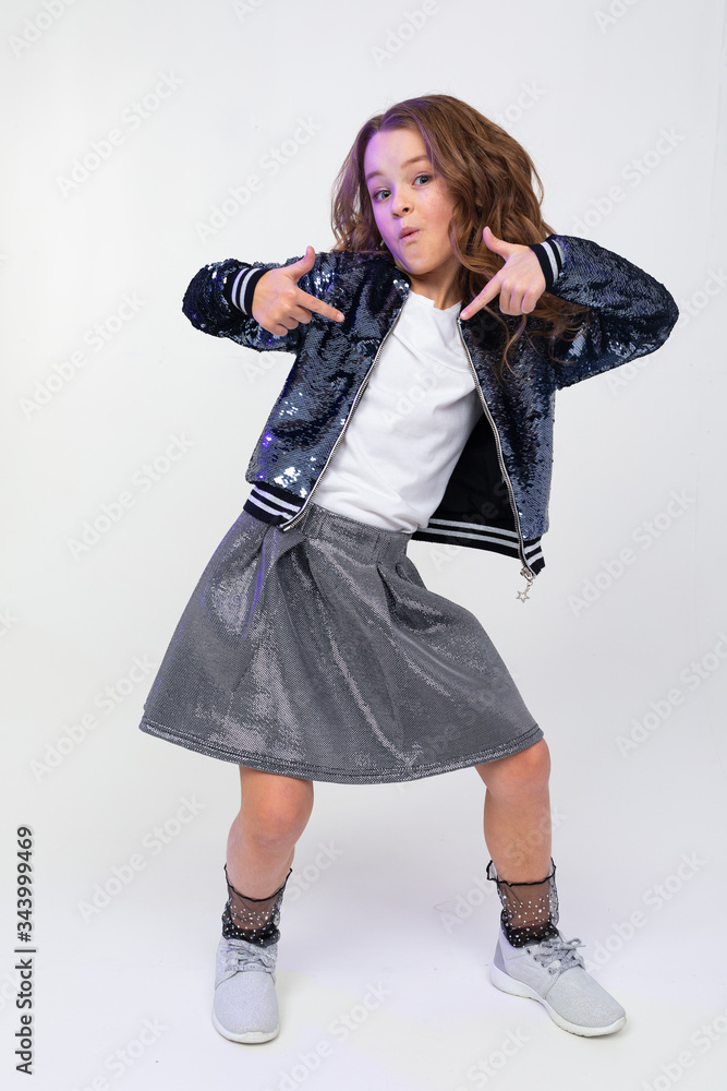 Photo of a cool attractive teenager girl showing super class on a white studio background Photo of a cool attractive teenager girl showing super class on a white studio background