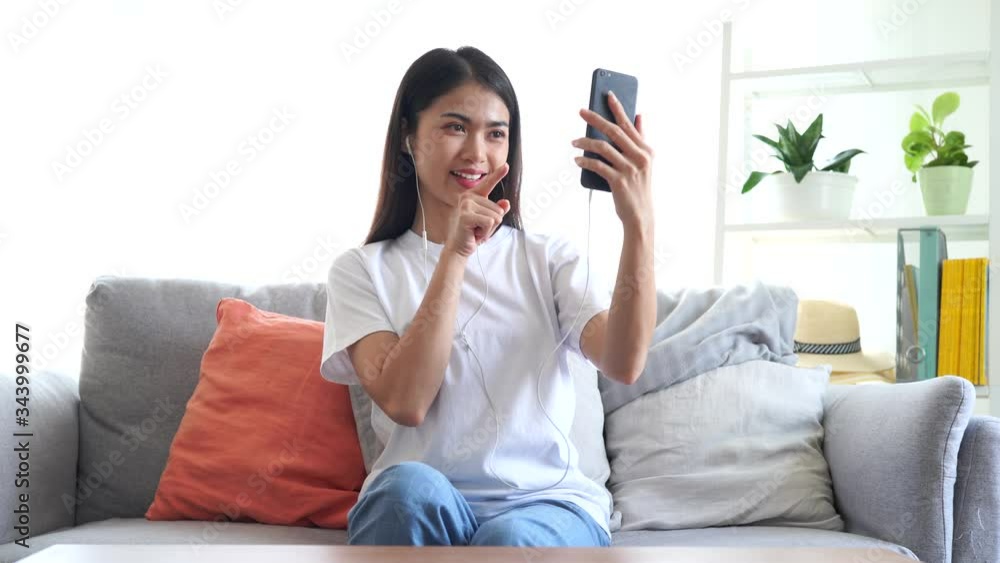 Beautiful young asian woman in white T-shirt are video calling by mobile phone with her friend. Beautiful young asian woman in white T-shirt are video calling by mobile phone with her friend.