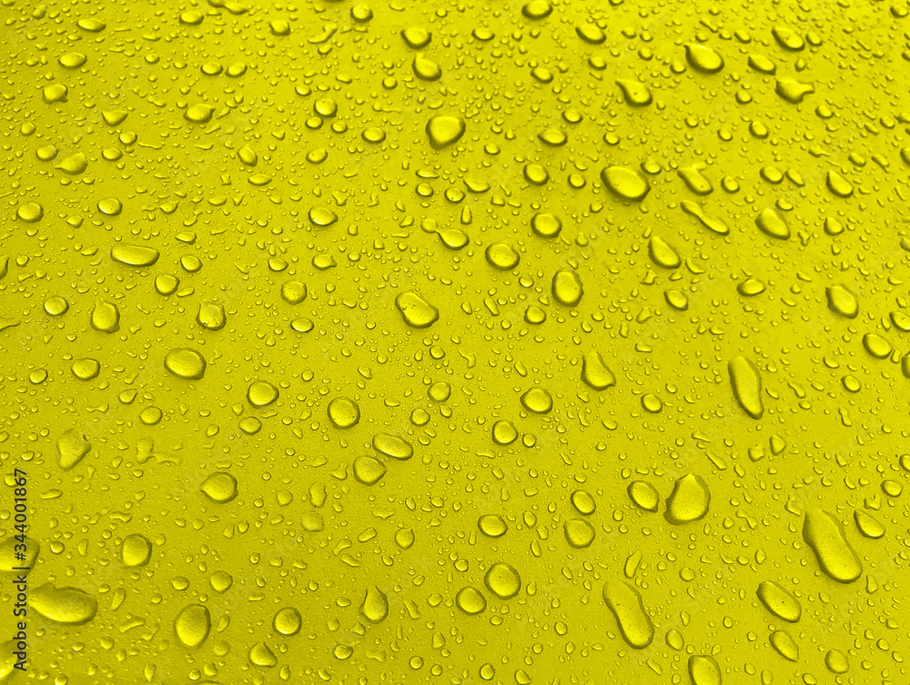 Drops of water on a yellow metal surface, beautiful background after rain Drops of water on a yellow metal surface, beautiful background after rain