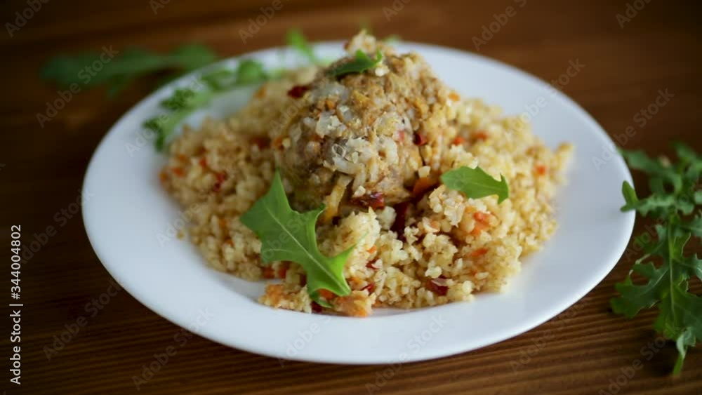 boiled bulgur groats with vegetables and meatballs in a plate boiled bulgur groats with vegetables and meatballs in a plate