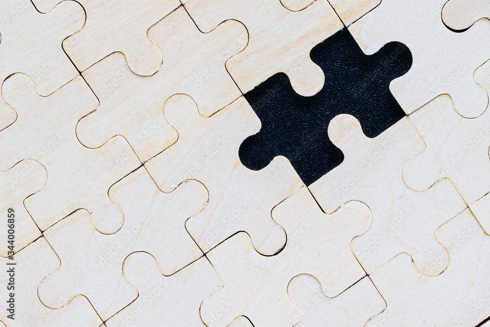 Close up wooden jigsaw puzzle pieces on black background Close up wooden jigsaw puzzle pieces on black background