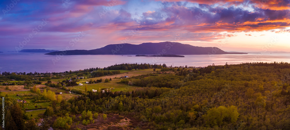 Dramatic Aerial Sunset View of Orcas Island, Washington. Drone aerial shot of Orcas Island located in the San Juan Islands and surrounded by the Salish Sea. Viewed from Lummi Island in the foreground.