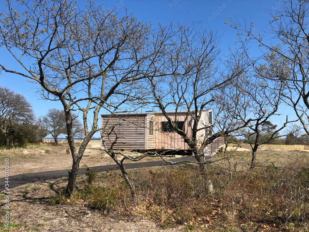 A Wooden Cabin Behind the Trees at Heckscher State Park in Great River, Long Island, New York. A Wooden Cabin Behind the Trees at Heckscher State Park in Great River, Long Island, New York.