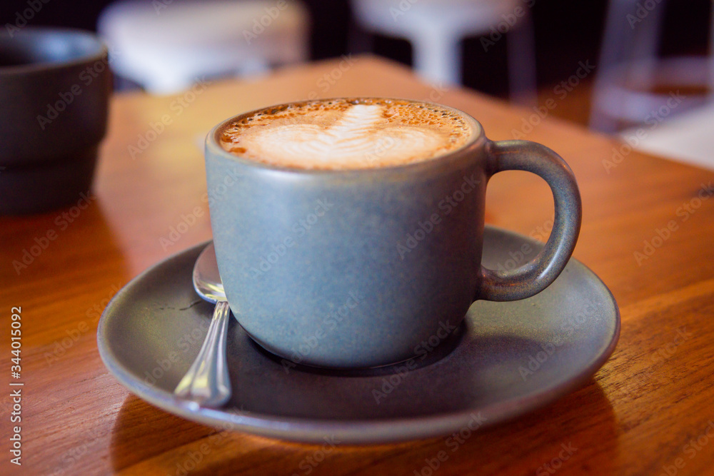 Cup of coffee on a wooden table. Hot cappuccino Cup of coffee on a wooden table. Hot cappuccino