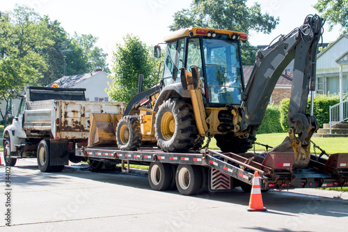 Heavy equipment delivered for working on a road and underground pipe job