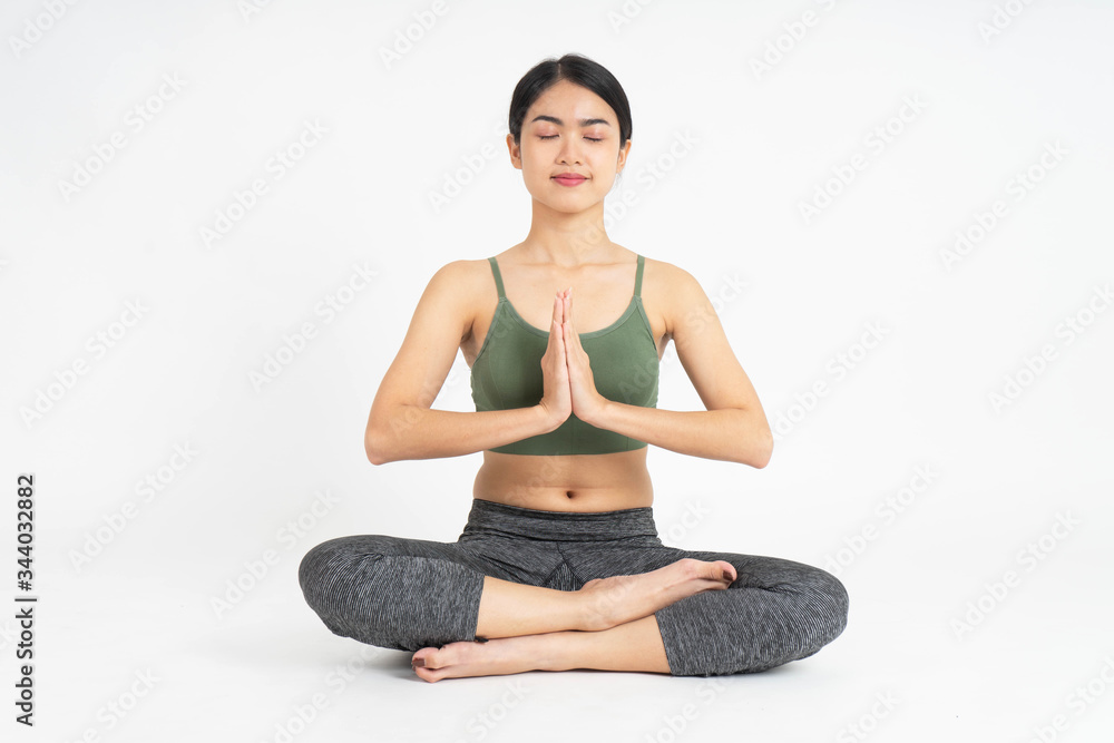 Young Asian woman yoga meditating on white background